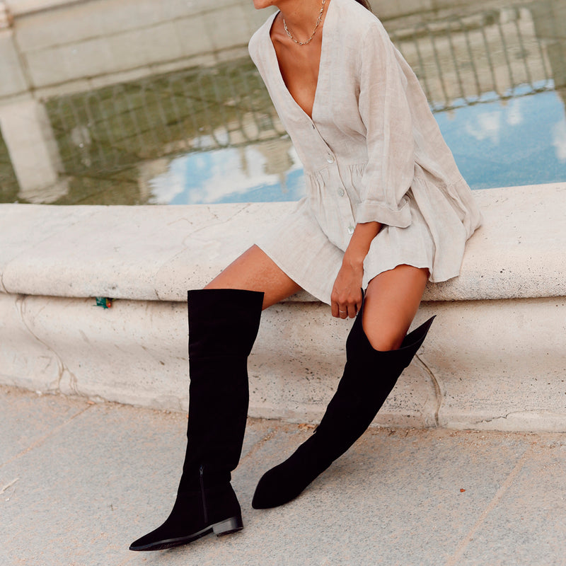 Black suede musketeer boot with black leather lining, elegant and chic, an ideal wardrobe essential. 
