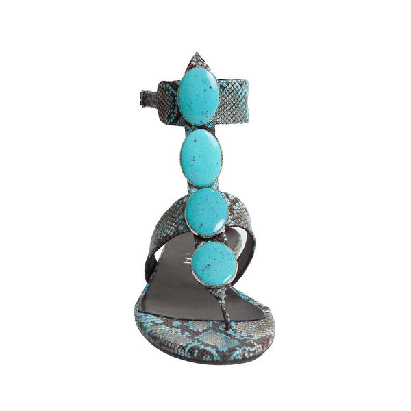 Woman's elegant flat sandal for an evening out blue python leather and turquoise stones