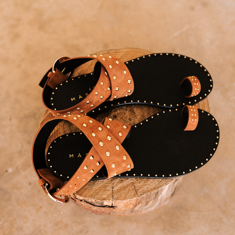 Summer flat sandals in cognac suede with gold studs
