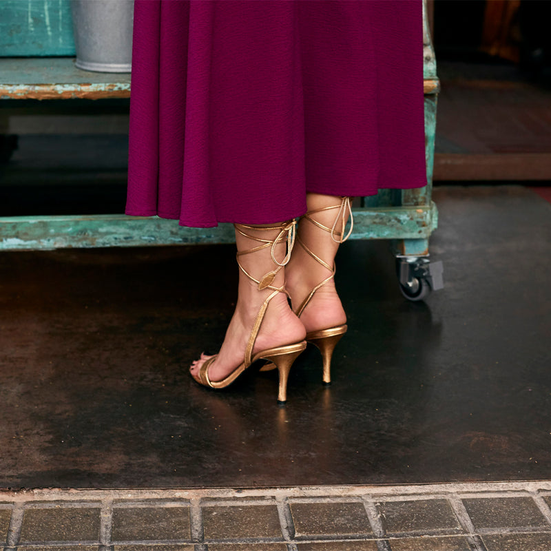 Golden sandal with 8 cm heel, with straps adjustment.